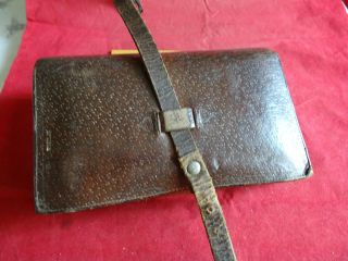 AN OLD VINTAGE LEATHER FISHING WALLET WITH EARLY FLOATS 2